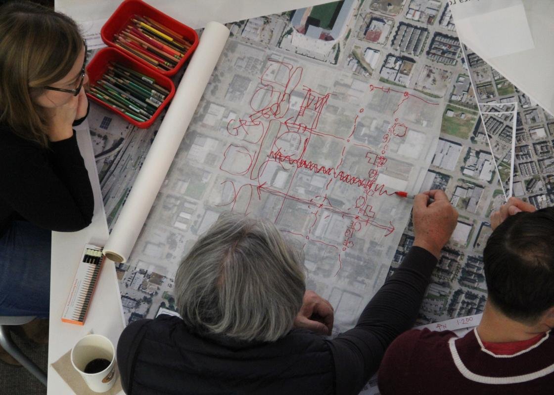 Three people looking at a plan