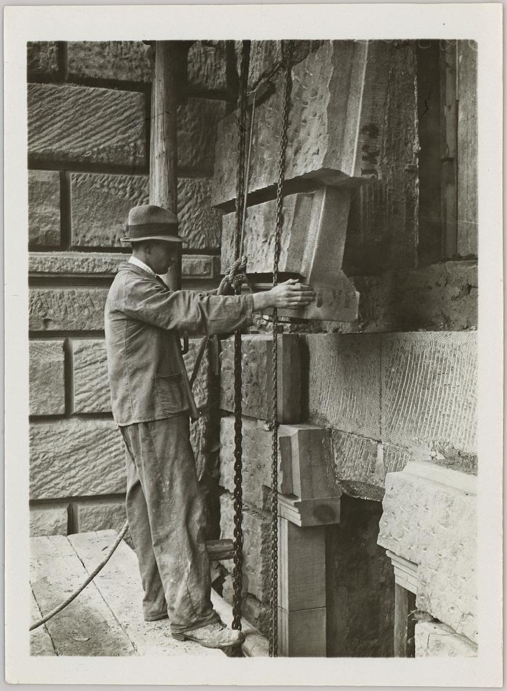 Gustav Gull, Swiss Federal Institute of Technology main building renovation, 1914–25. A man installing an artificial stone block on the facade of the south wing, anonymous photograph, November 1921. Courtesy gta Archiv / ETH Zürich, Gottfried Semper.