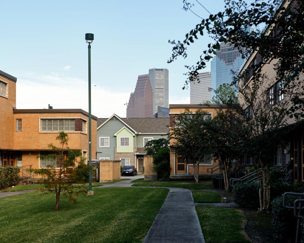 Figure 10. San Felipe Courts, now known as Allen Parkway Village, today. In front are the original Kamrath buildings, in the middle distance are newer townhouse structures, and in the background, the downtown cityscape. Photo by Leonid Furmansky.